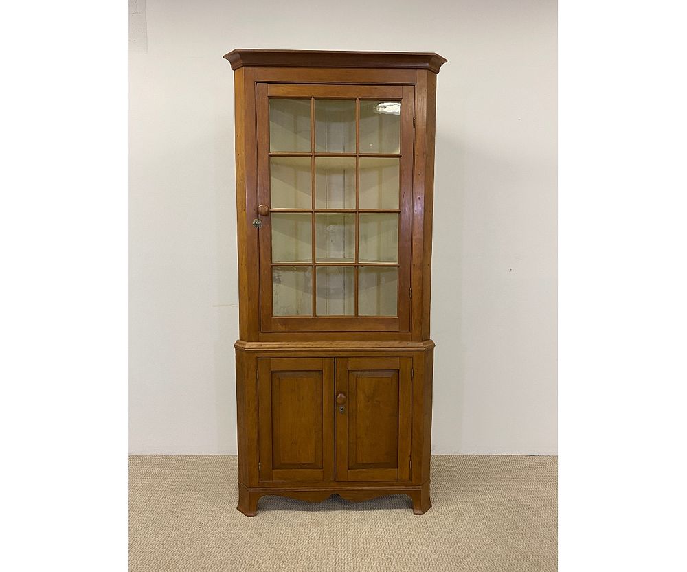 Appraisal: Pennsylvania Cherry Corner Cupboard Pennsylvania cherry two piece corner cupboard