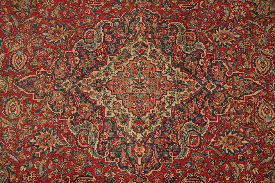 Appraisal: A PERSIAN STYLE CARPET of Isfahan design the madder ground