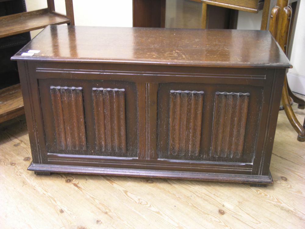 Appraisal: A dark oak coffer with linenfold panels to the front