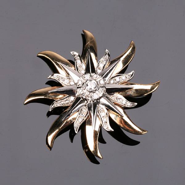 Appraisal: A diamond and fourteen karat two-tone gold sunburst brooch set