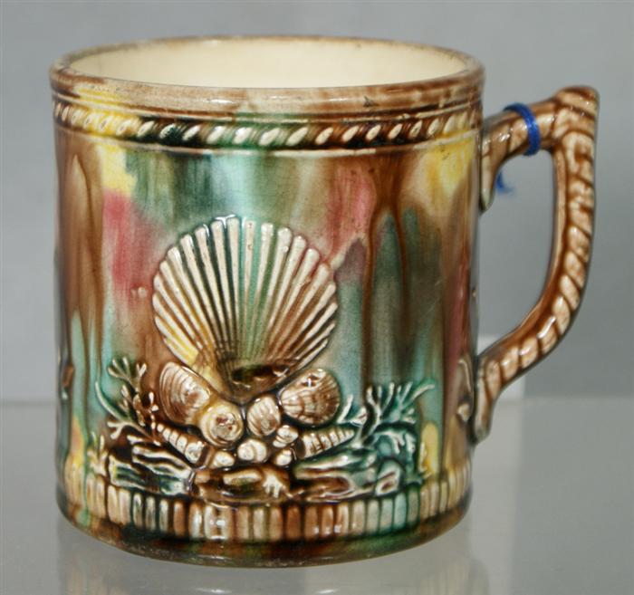 Appraisal: Majolica mug with shell and anchor motif against a brown