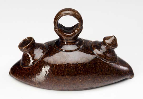 Appraisal: GEORGE OHR Sad iron covered in brown speckled glaze Incised