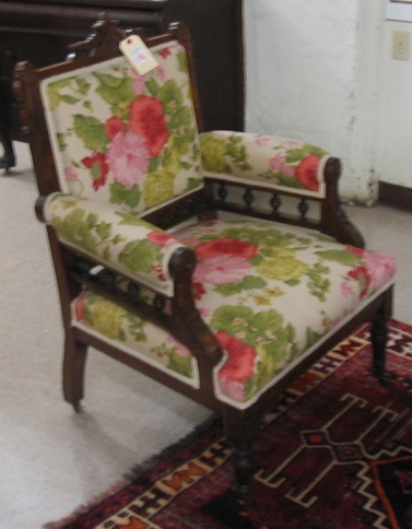 Appraisal: A PAIR OF VICTORIAN CARVED AND UPHOLSTERED WALNUT ARMCHAIRS Eastlake