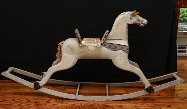 Appraisal: A TH CENTURY CARVED AND PAINTED ROCKING HORSEThe joined and