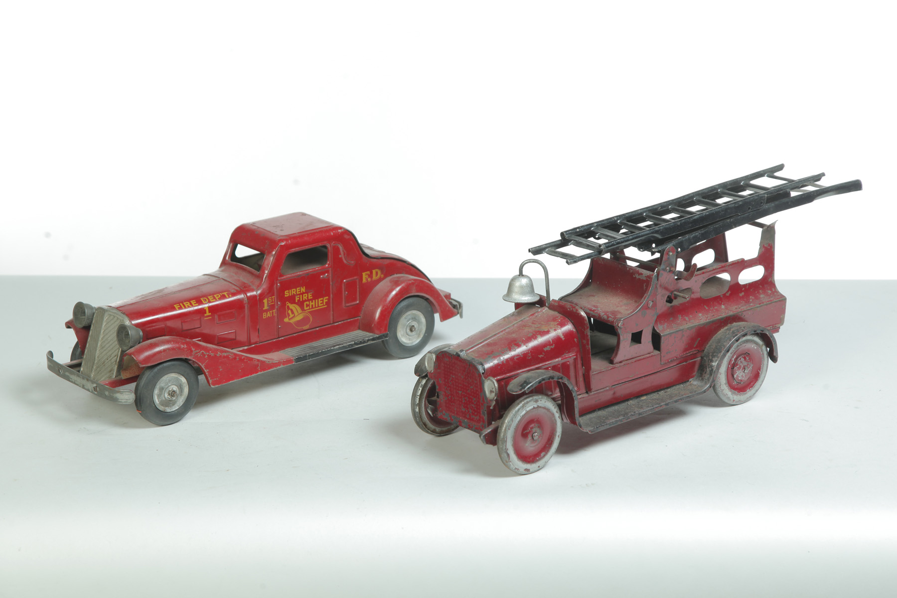 Appraisal: TWO TIN FIRE DEPARTMENT TOY VEHICLES American st half- th