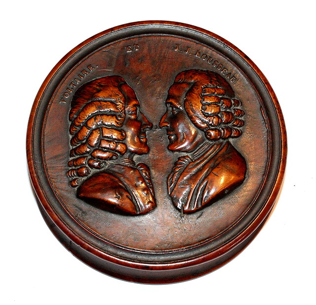 Appraisal: A CIRCULAR FRUITWOOD SNUFF BOX the lid carved with the