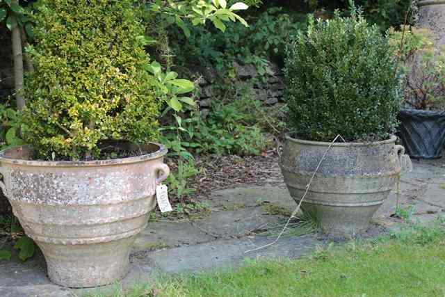 Appraisal: A PAIR OF CRETAN TERRACOTTA PLANTERS of turned tapering form