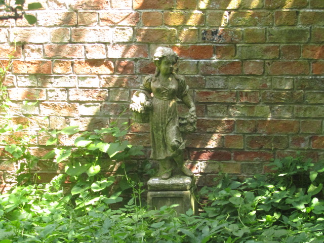 Appraisal: A pair of garden statues of a young boy and