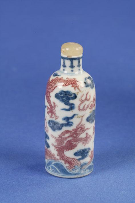 Appraisal: A CYLINDRICAL BOTTLE decorated in iron red and blue with