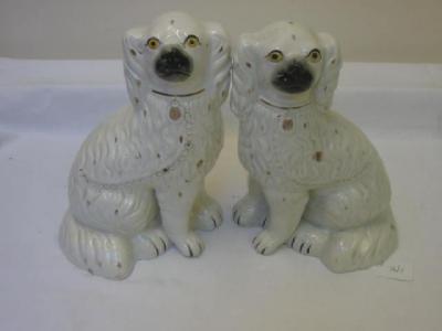 Appraisal: A PAIR OF VICTORIAN STAFFORDSHIRE POTTERY SPANIELS modelled seated with