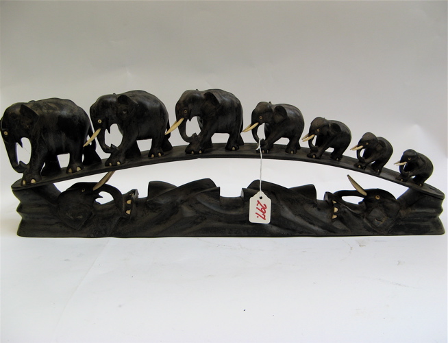 Appraisal: A HEAVY EBONIZED WOOD CARVING seven elephants in graduated sizes