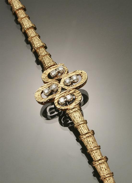 Appraisal: -Karat Yellow-Gold White-Gold and Diamond Bracelet The central floral motif