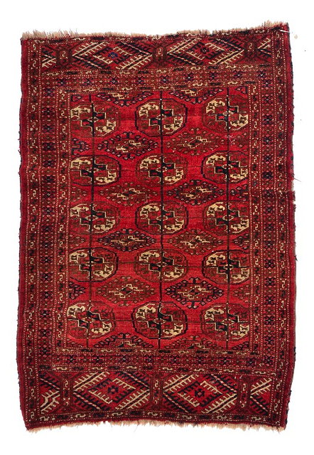 Appraisal: A PERSIAN YOMUT MID RED GROUND RUG decorated rows of