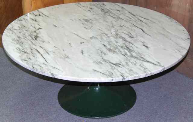 Appraisal: A marble topped coffee table in the manner of Eero