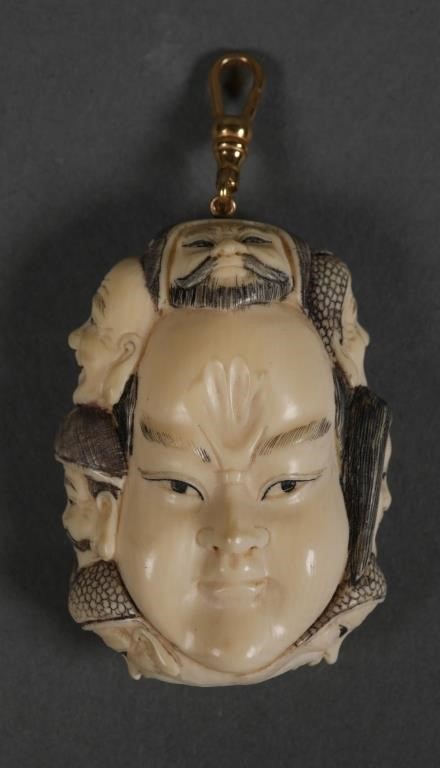 Appraisal: Japanese netsuke with multiple faces carved on boths sides and