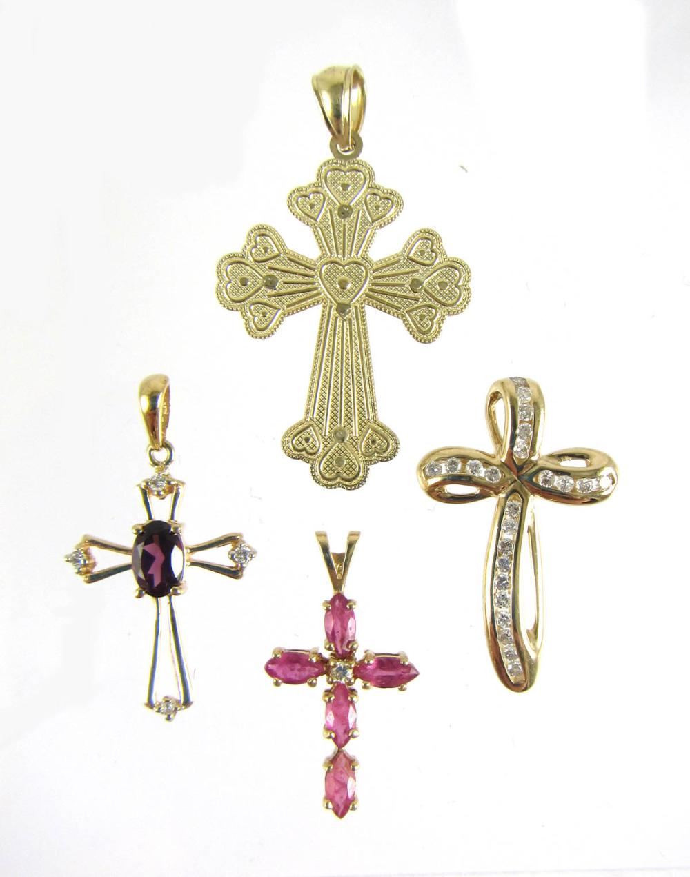 Appraisal: FOUR FOURTEEN KARAT GOLD CROSS PENDANTS k gold reversible cross