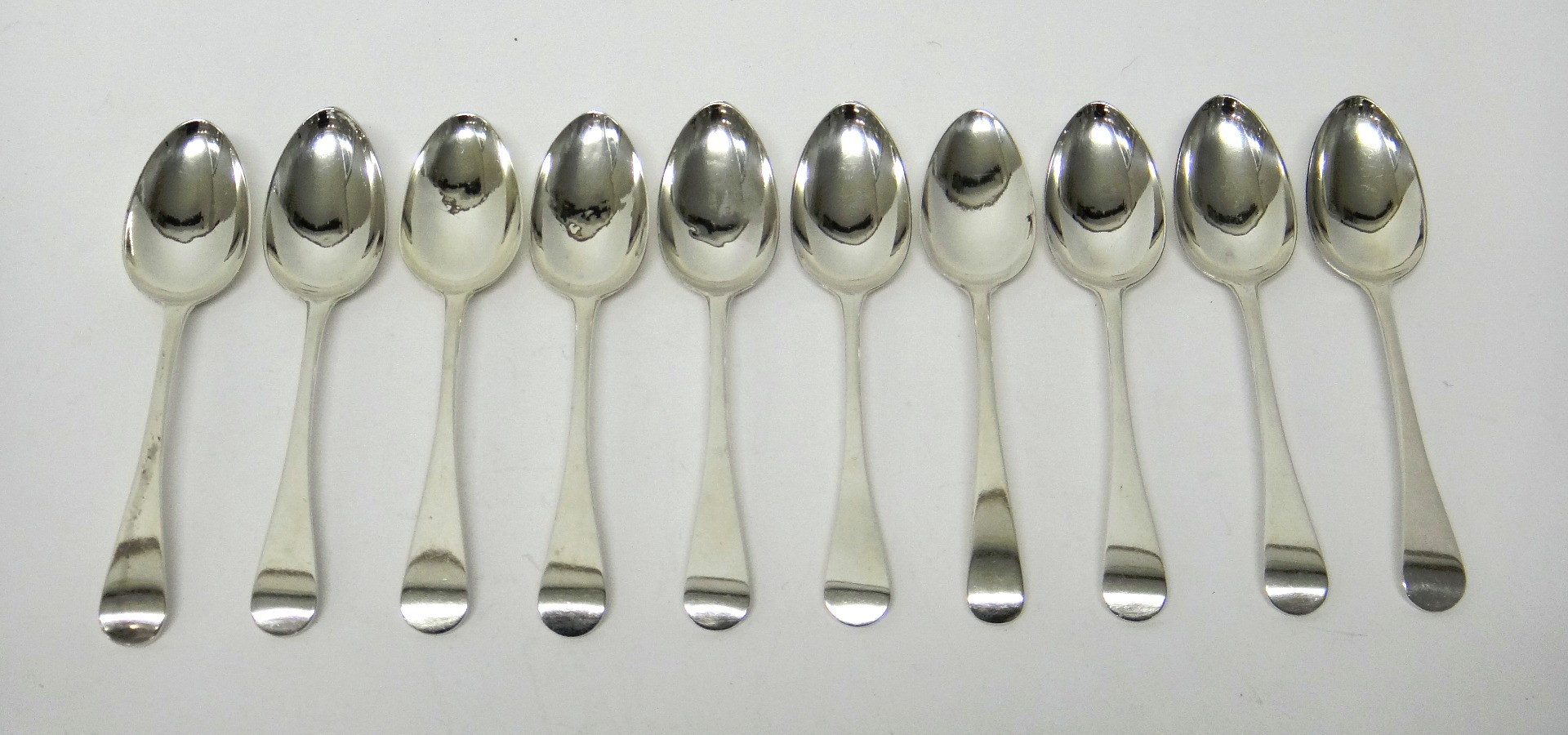 Appraisal: Ten silver Old English pattern dessert spoons comprising nine London