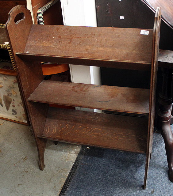 Appraisal: AN OLD OAK BOOKSHELF with angled book stands and pierced