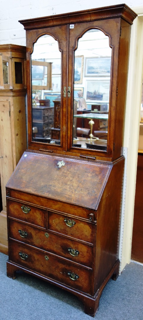 Appraisal: An early th century style featherbanded figured walnut bureau bookcase