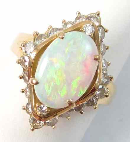 Appraisal: OPAL DIAMOND AND FOURTEEN KARAT GOLD RING round-cut diamonds surround