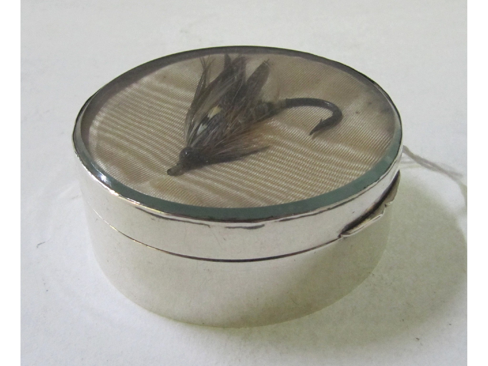 Appraisal: A silver box the hinged lid set with a fishing