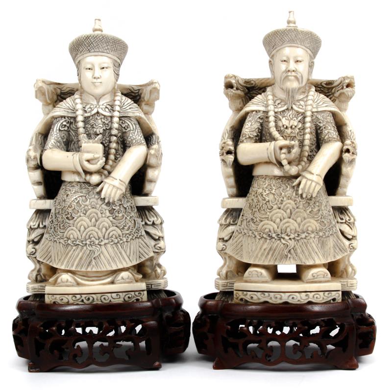 Appraisal: Pair of Chinese carved ivory figures of enthroned Emperor and