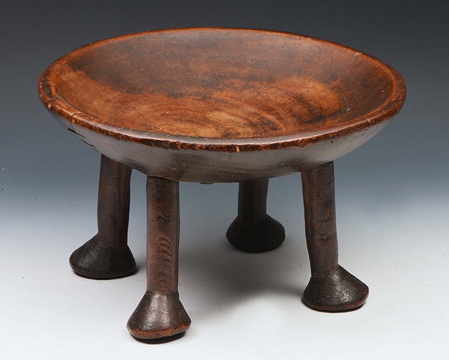 Appraisal: AN AFRICAN CIRCULAR BOWL on four legs with elephant pad