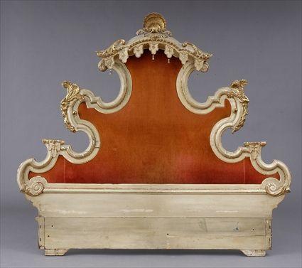 Appraisal: VENETIAN ROCOCO-STYLE CARVED CREAM-PAINTED AND PARCEL-GILT HEADBOARD The padded panel