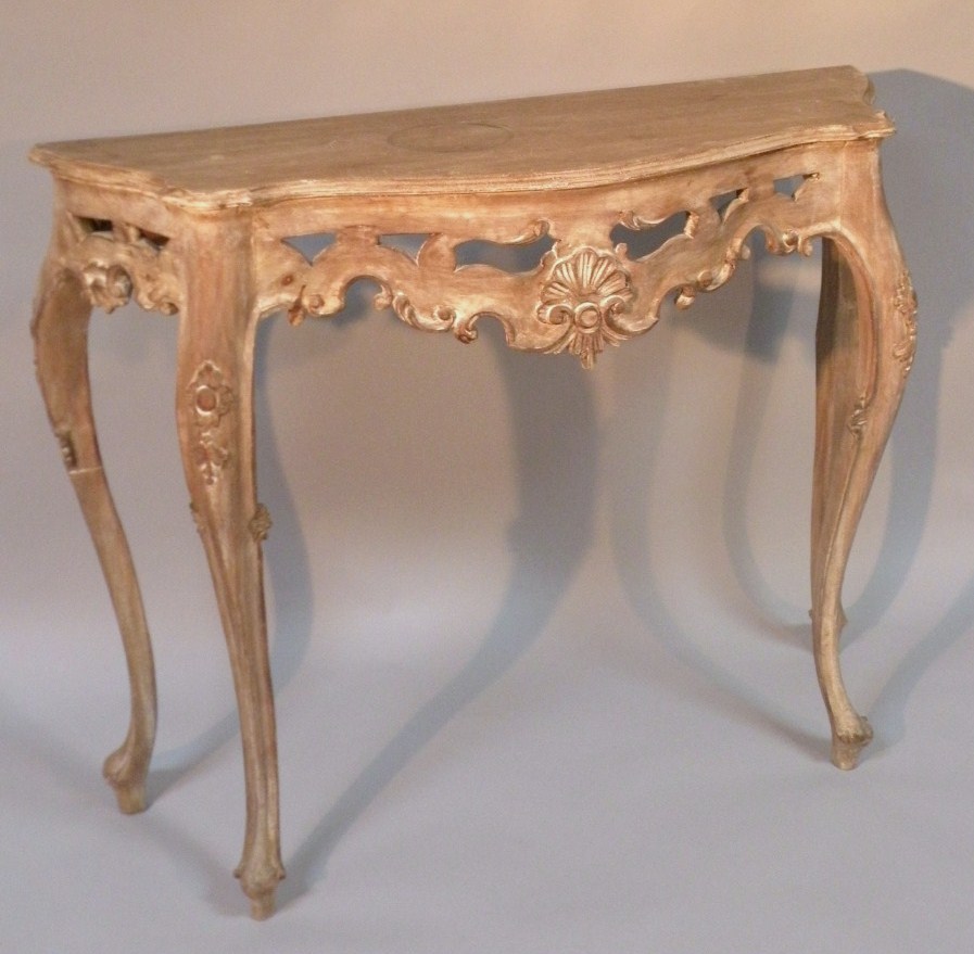 Appraisal: A lightwood baroque design console table the shaped carved top