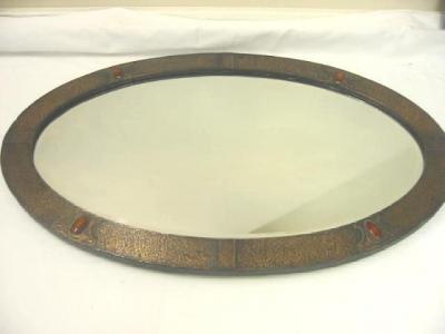 Appraisal: AN ARTS AND CRAFTS WALL MIRROR of oval form the