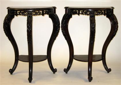 Appraisal: Pair of Anglo-Chinese carved mahogany consolesEach with a demilune top