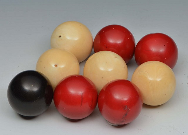 Appraisal: A COLLECTION OF NINE IVORY AND STAINED IVORY BALLS