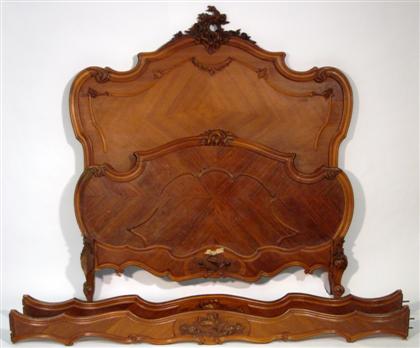 Appraisal: Louis XV style carved walnut bedstead The shaped and channeled