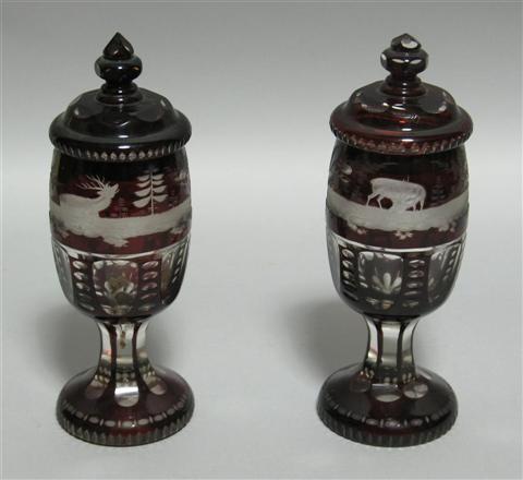 Appraisal: PAIR OF BOHEMIAN GLASS COVERED URNS Both with thick pedestals