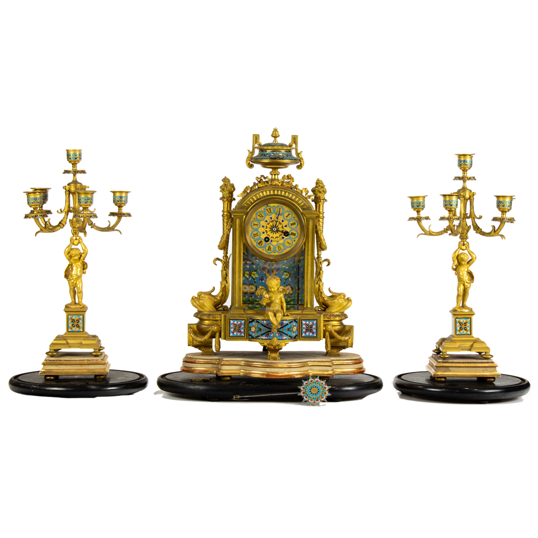 Appraisal: A FRENCH GILT BRONZE AND CHAMPLEVE ENAMEL CLOCK GARNITURE RETAILED