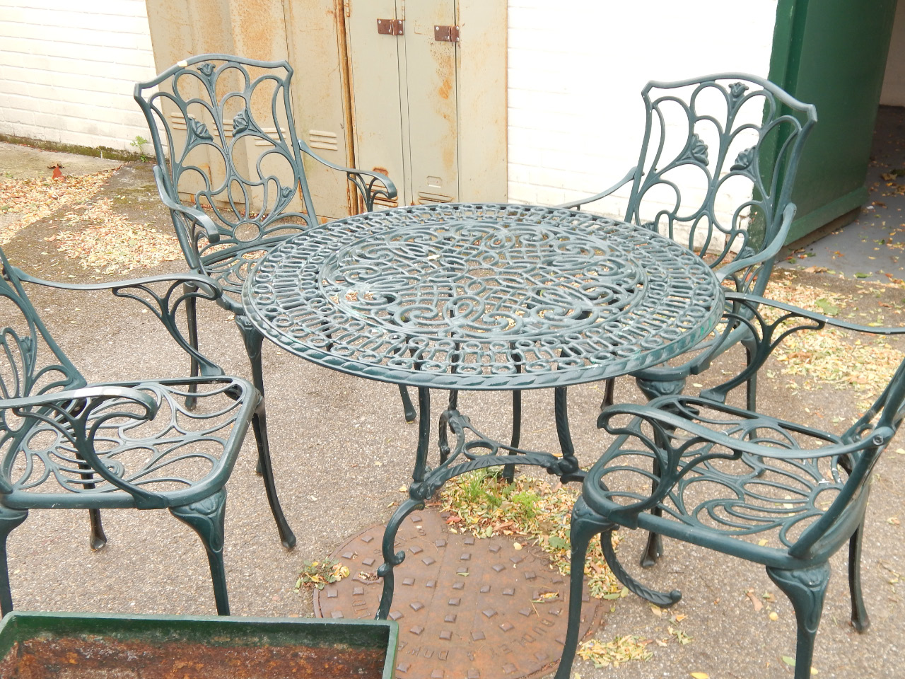 Appraisal: A cast aluminium alloy circular garden table and four Art