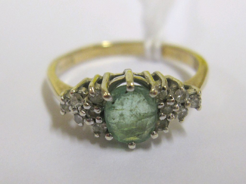 Appraisal: Nine carat gold emerald and diamond cluster ring