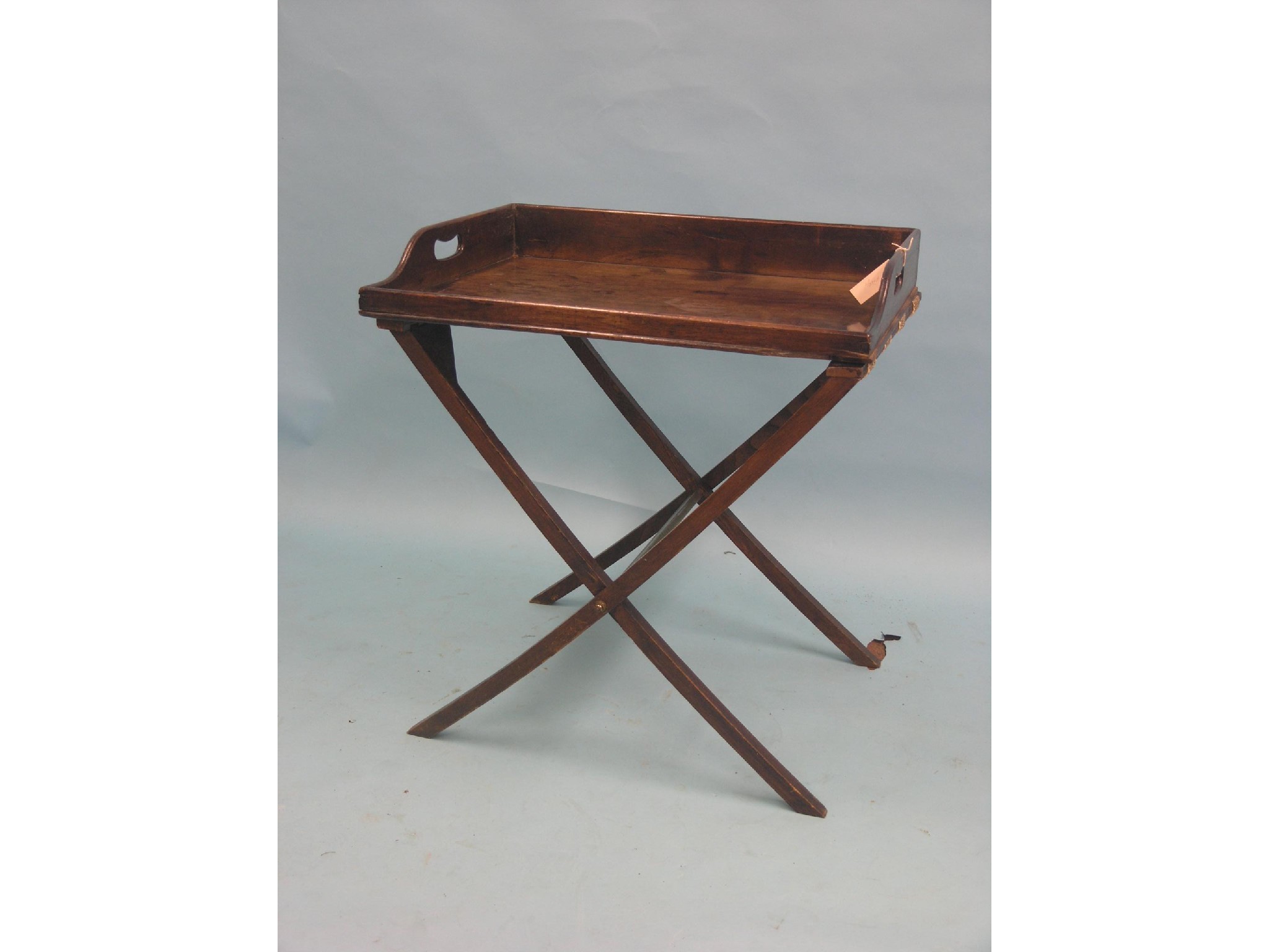 Appraisal: A th century mahogany butler's tray rectangular-shape on folding oak