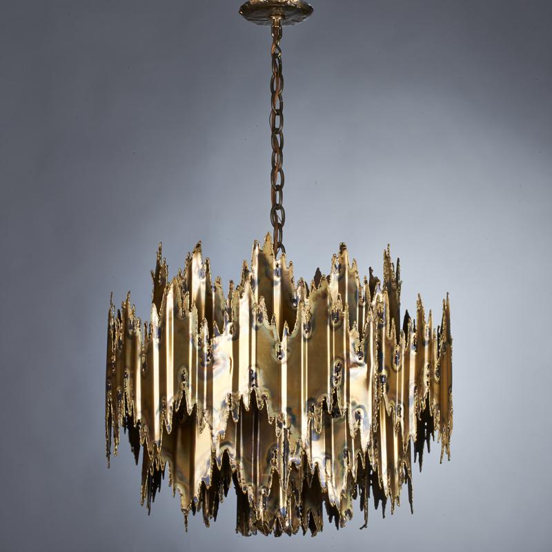 Appraisal: TOM GREEN Brutalist seven-light chandelier s Hand-torched patinated brass Unmarked