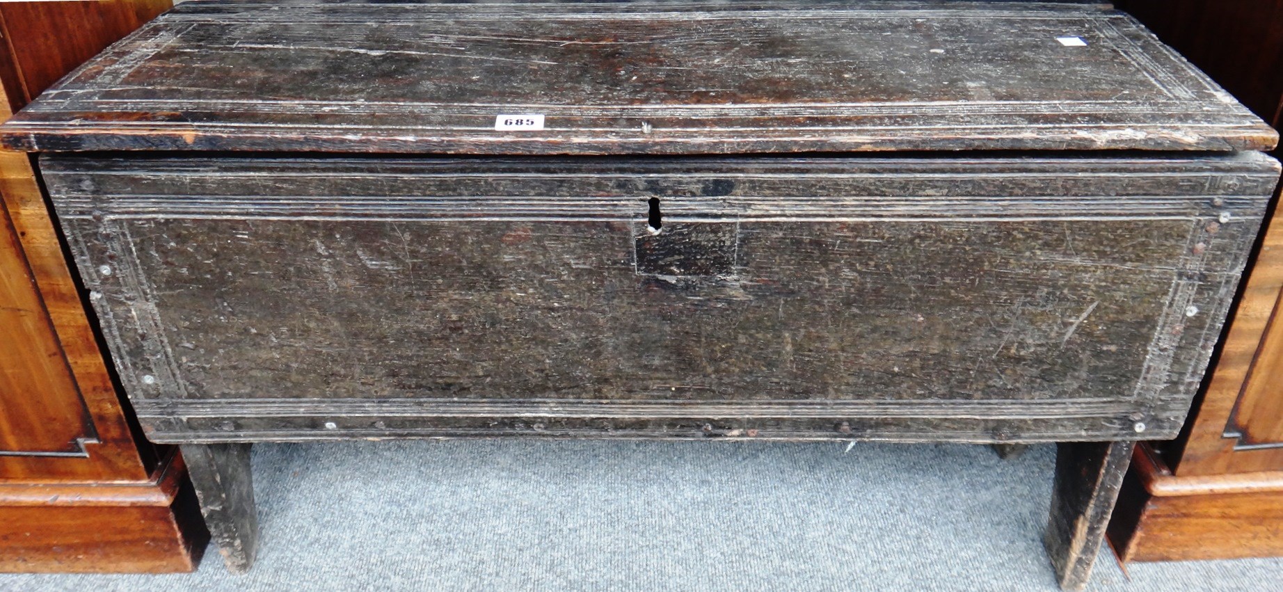 Appraisal: A th century oak five plank coffer on slab end