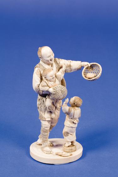 Appraisal: A JAPANESE IVORY OKIMONO of a fisherman carrying a basket