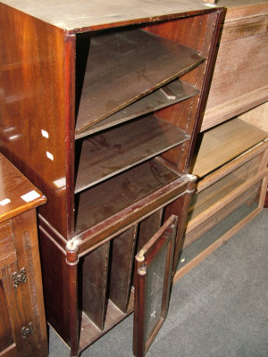 Appraisal: A mahogany music cabinet with two glazed doors above sectioned