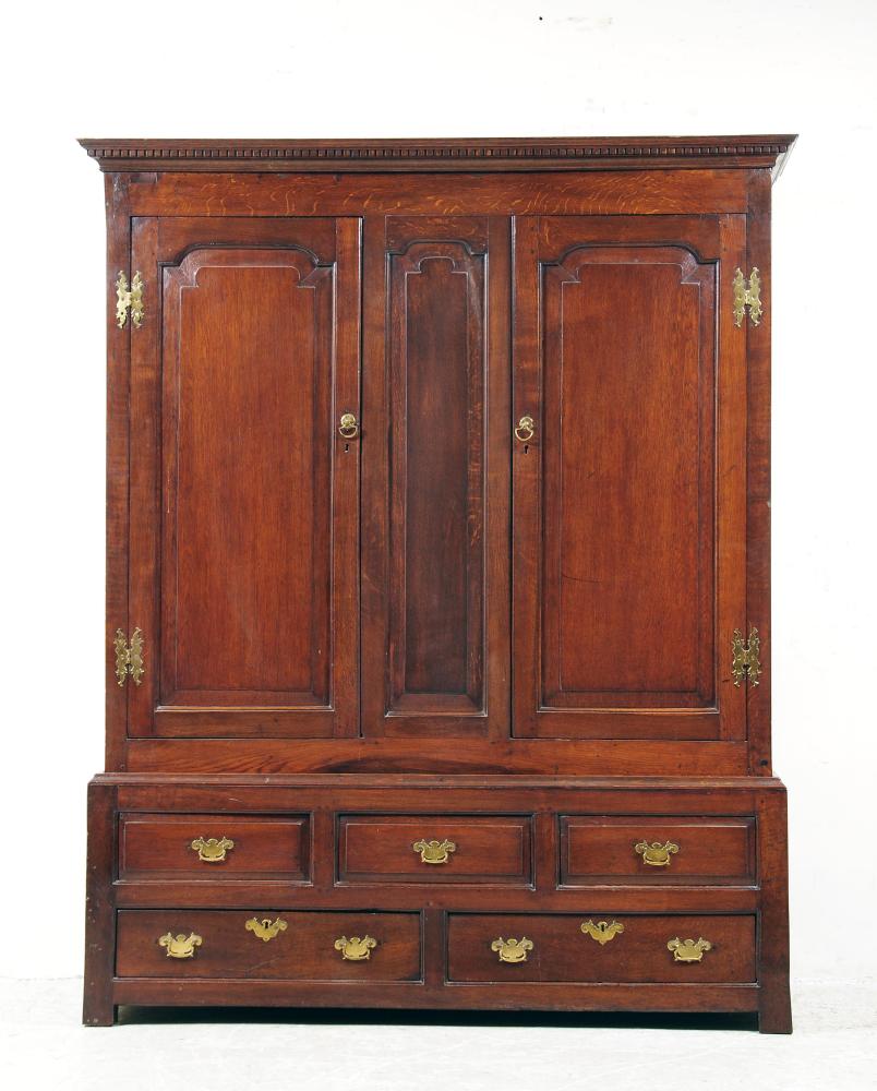 Appraisal: A GEORGE III OAK LIVERY CUPBOARD th century the dentil