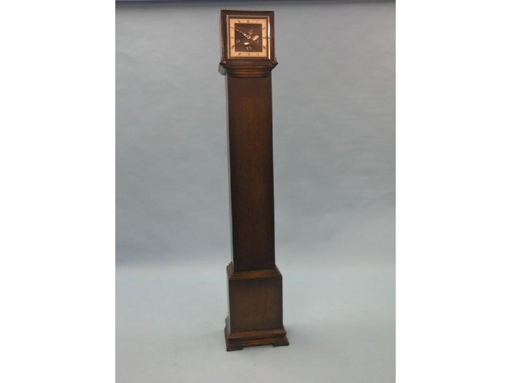 Appraisal: A dark oak-veneered grandmother clock square dial with silvered chapter