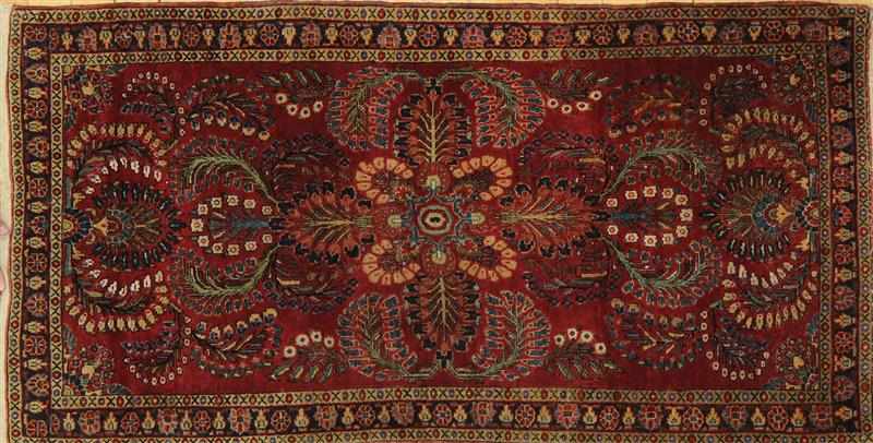 Appraisal: PERSIAN WINE RED-GROUND RUG Worked floral bursts and wreaths within