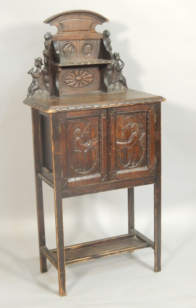 Appraisal: A late thC oak side cabinet the raised back carved