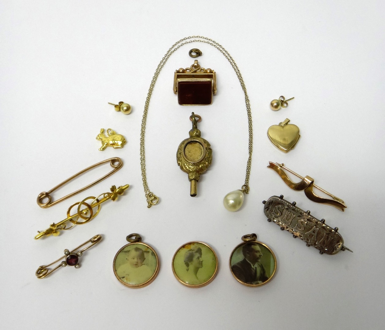 Appraisal: A gold bar brooch with trefoil motifs a gold garnet