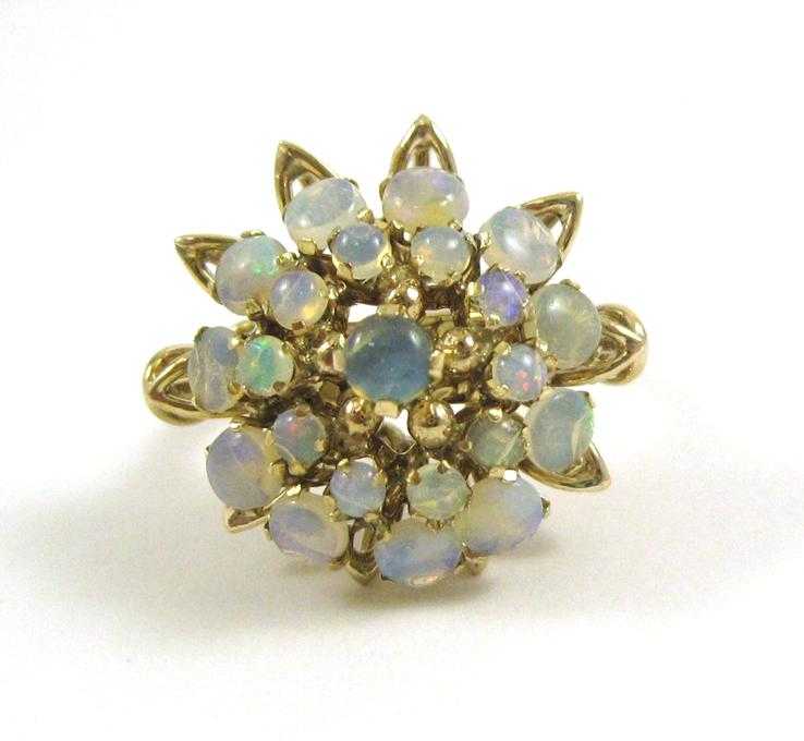 Appraisal: OPAL AND TEN KARAT GOLD CLUSTER RING set with a