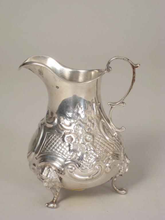 Appraisal: A Victorian baluster Cream Jug with floral and trellis embossing