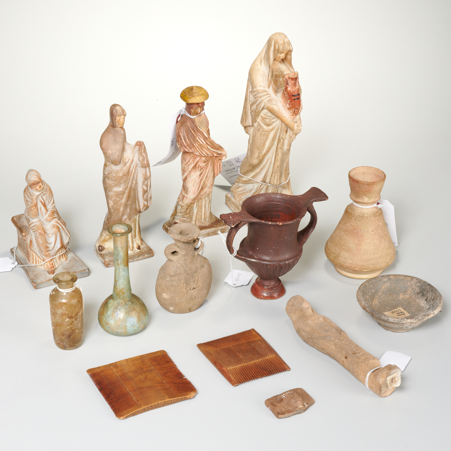 Appraisal: COLLECTION ANCIENT AND ANCIENT STYLE ARTIFACTS Includes Roman glass bottles